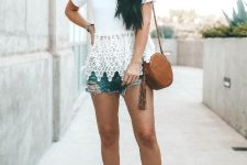 With distressed denim shorts, brown rounded bag and platform sandals