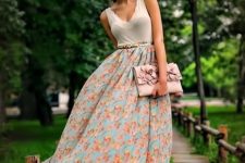 With floral maxi skirt, pale pink clutch and high heels