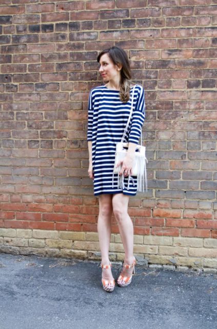 With navy blue and white striped mini dress and white fringe bag