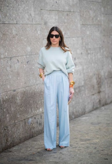 With pastel colored loose sweater and sandals