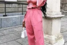 With pink jogger pants, white mini bag and transparent shoes