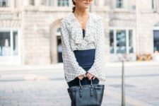 With polka dot ruffled blouse, navy blue midi skirt and black tote bag