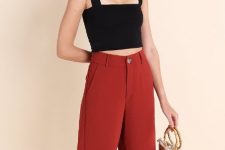 With red culottes and beige bag