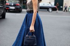 With silver sleeveless top, black belt, navy blue leather mini bag and silver ankle strap high heels