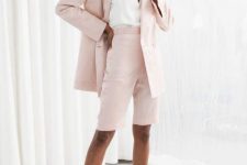 With white V-neck top, pale pink blazer and silver mules