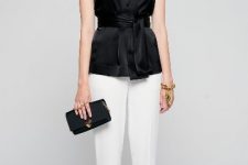 With white cropped trousers, white ankle boots and black clutch