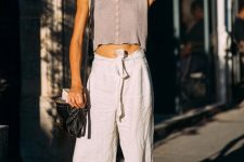 With white linen belted palazzo pants, sandals and black bag