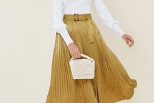 With white long sleeved shirt, beige bag and white lace up sandals