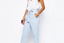 With white sleeveless top, mini clutch and white ankle strap high heels