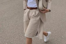 With white t-shirt, beige long blazer, white sneakers and beige leather bag