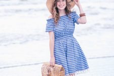 With wide brim hat, straw bag and white and beige flat sandals