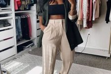 a black crop top, neutral linen trousers, a dark green oversized blazer, black dad sandals are a great and trendy look for summer