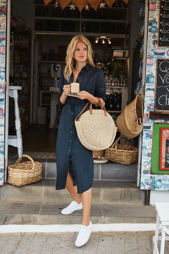 a black linen midi shirtdress, white sneakers, a round straw bag for a hot summer day