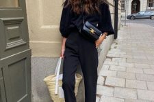 a black long sleeve top, black trousers, black dad sandals and a straw bag for a comfortable summer work look