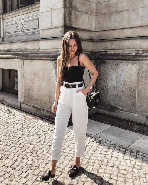 a black spaghetti strap top, white cropped pants, black mules and a black bag for a chic and cool hot day look