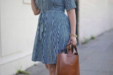 a blue gingham over the knee dress with a sash, brown strappy shoes and a brown tote for an easy and comfy look