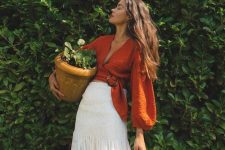 a boho summer outfit with an orange cropped blouse with puff sleeves and a white midi skirt is cool and relaxed