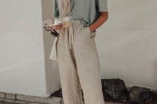 a casual look with an oversized linen tee, neutral pants, slippers and a white shopper bag