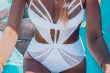 a chic white one piece swimsuit with a cool design, cutout sides and parts over the chest is wow