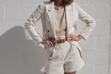 a classy look with a neutral top and a white linen short suit plus a brown belt is an ultimately elegant look