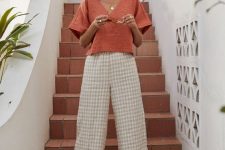 a creative vacation look with an orange oversized linen top and gingham pants, yellow mules for summer