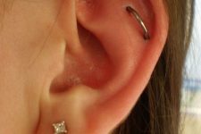 a lobe piercing paired with an orbital flat, with a diamond and a simpel hoop earring