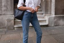 a lovely casual work look with a white shirt, blue jeans, black dad sandals, a black bag and a necklace is cool for summer