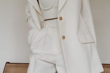 a luxurious work look with a white linen pantsuit with an oversized blazer and a neutral crop top with spaghetti straps