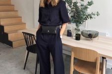 a navy linen jumpsuit, a black belt bag and black Birkenstocks for a chic summer work look