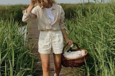 a neutral linen shirt and a white t-shirt, neutral linen shorts, white sneakers, a basket for a picnic are lovely