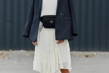 a neutral midi dress with an asymmetrical skirt, black dad sandals, a navy blazer and a black belt bag for an elegant work look