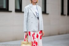 a printed t-shirt, a bold printed midi skirt, black strappy heels, a neutral bag and a pinstriped blazer for a cooler evening