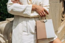 a refined summer work look with a nude silk top, a white linen short suit, layered necklaces and a two tone bag