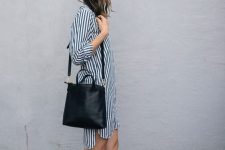 a striped black and white shirtdress, a black bag and grey birkenstocks compose a simple and cool summer outfit