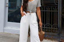 a striped t-shirt tied up, white culottes, elegant nude heels, a bucket bag and sunglasses for a hot day