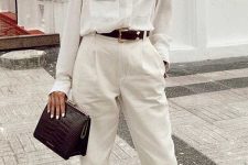 a stylish work outfit with a white shirt and pants, a black belt, a chocolate brown bag and nude slipper mules