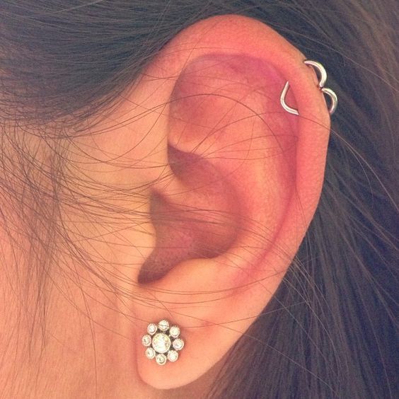 a traditional lobe piercing paired with an orbital one, with a lovely small heart earring are a very cool combo
