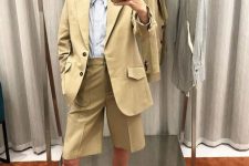 a trendy summer outfit with a blue striped shirt, an olive green linen short suit with Bermudas, bright green sandals