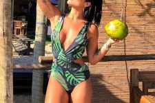 a tropical leaf print one piece swimsuit with a deep neckline and side cutouts is a bold and sexy idea