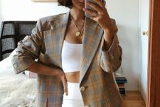 a white crop top and biker shorts, a bright plaid oversized blazer and layered necklaces