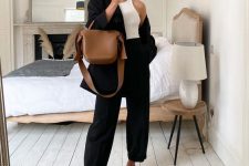 a white halter neckline top, black high waisted trousers, black dad sandals, a black oversized blazer and a brown bag for an elegant work look