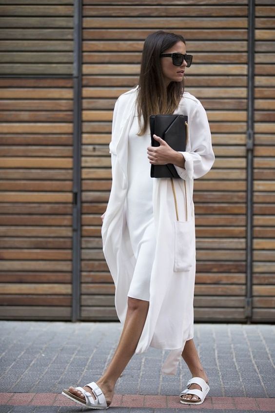 a white knee dress, white duster, birkenstocks and a black clutch for a minimal and chic look