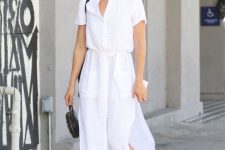 a white linen midi shirtdress with short sleeves, black mules and a black round bag for a hot working day