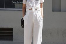 a white linen tied up shirt, white linen pants, nude sandals, a black round bag are a cool minimal look for summer