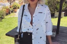 a white printed shirt, a black denim mini, a black bag and a necklace are all you need to feel comfy on a hot day