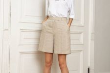 a white printed tee, neutral linen Bermudas, black strappy heels for a neutral and non-boring look
