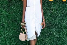 a white sleeveless knee shirtdress with pockets, white sneakers and a blush bag with a ring handle will keep you cool