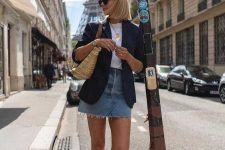 a white t-shirt, a navy blazer, a blue denim mini, white sneakers and a straw bag for a casual summer look