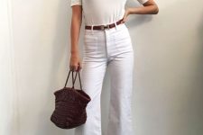 a white t-shirt, white jeans, a brown belt, shiny metallic heels and a burgundy bag