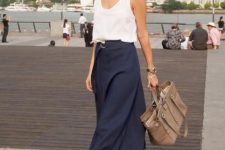 a white top, a navy midi skirt with a belt, comfy heels and a grey tote for a hot summer day